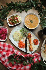 Turkish Adana Kebab with fresh vegetables on flatbread Top view, flat lay