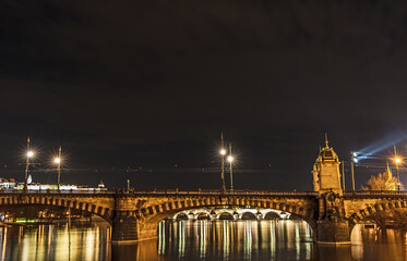 Night shot of Legion Bridge - Most Legií - over river Vltava in Prague, with Charles Bridge and Prague Castle; taken from Slovansky ostrov