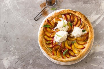 hot, homemade pie with peaches on a gray background. healthy food, comfort, holiday, vacations, dessert concept.
