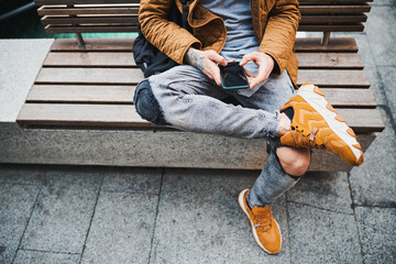 Urban citizen spending time online outdoors with device