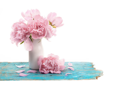 Bouquet of peonies flowers in white vase isolated on white