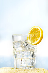 Glass of water on beach and sea landscape 