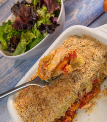 Salmon Parmentier recipe with hazelnuts, young salad leaves. High quality photo