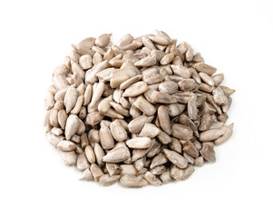 pile of unpeeled sunflower seeds closeup on white