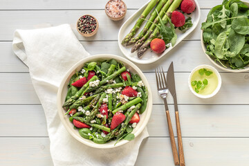 Strawberry, spinach, green asparagus, arugula, and feta cheese salad.