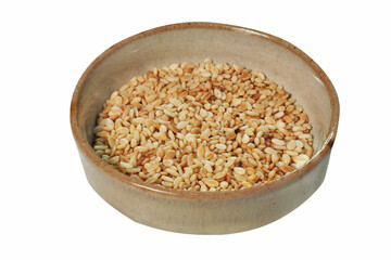 White sesame seeds in bowl isolated on white background. Image stacked with clipping path for advertisement. Healthy food, Vegetarian diet food.