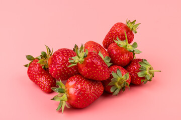 Strawberries on pink background. Creative food concept. Flat lay, top view, copy space