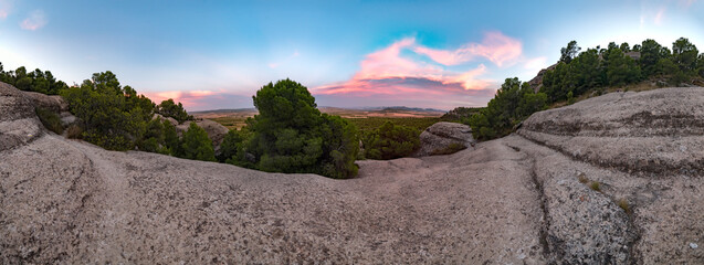 Pink sunset from an ancestral mountain, Mount Arabi, Yecla, Spain. Panoramic of a sunset in the...