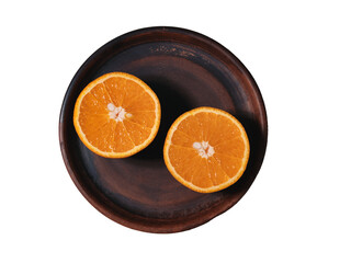 Fresh and juicy orange on a clay plate. Sliced orange. Top view