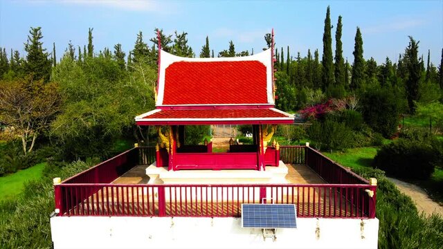 Aerial Shot Of Thai Pagoda Located In Ben Shemen Forest, Drone Descending Over Structure On Sunny Day
