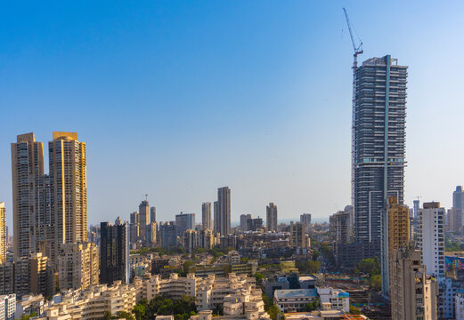 Mumbai, Maharashtra - April 5 2021: HDR image of Antilia Building shot against the sky with other city street buildings