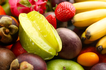 Assortment of fresh exotic fruits as background, closeup