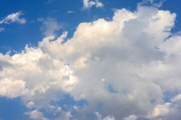 Naklejka na ściany i meble Beauty is in nature. A large cumulus cloud against a blue sky.