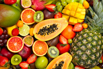 Many different delicious exotic fruits as background, top view