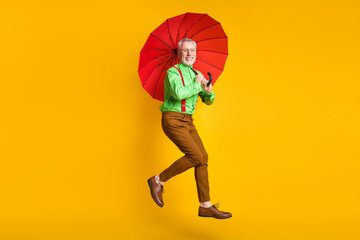 Full length profile photo of funny elder man jump hold parasol wear spectacles shirt trousers...