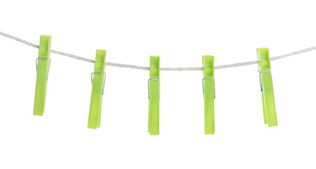 Bright green plastic clothespins hanging on rope against white background