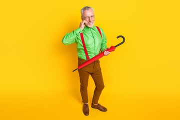 Top above high angle view full size photo of aged man happy positive smile wink eye hold parasol isolated over yellow color background