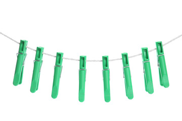 Green plastic clothespins hanging on rope against white background