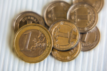 Euro currency coins coins on a white background. Inflation, business, economics and finance theme.