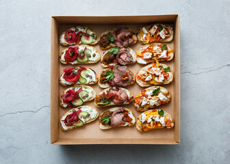 
A set of different snacks for a party or a festive table. Ciabatta sandwiches with tomatoes,...