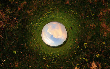 Stereographic panoramic projection of a filed in sunset light. 360 degree panorama. - obrazy, fototapety, plakaty