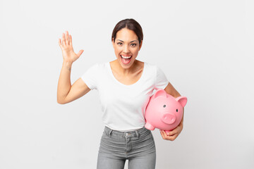 young hispanic woman with a piggy bank
