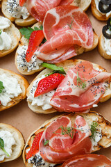 
A set of different snacks for a party or a festive table. Ciabatta sandwiches with tomatoes,...