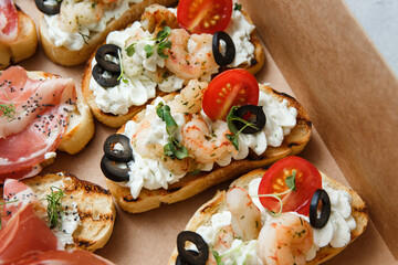 
A set of different snacks for a party or a festive table. Ciabatta sandwiches with tomatoes,...