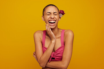 Laughing female model with flowers on head