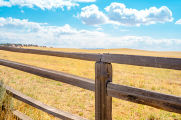 Beautiful rustic landscape with field and wooden fence, natural background