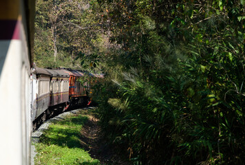 The express train is going to the high mountain with the multiple diesel-electric locomotives.