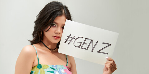 Beautiful asian woman holding a paper with #GENZ