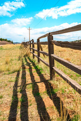 Obraz premium Beautiful rustic landscape with field and wooden fence, natural background