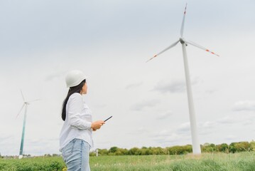 researcher analyzes readouts on wind power station