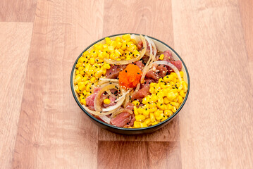 bowl of red tuna with lots of sweet corn, onion, fish roe