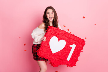 Photo of young attractive girl happy positive smile hold paper pinata like icon isolated over pastel color background