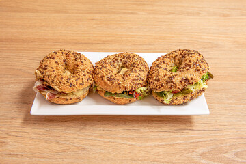 Trio of bagels filled with lettuce and Iberian ham with lots of sesame and poppy seeds