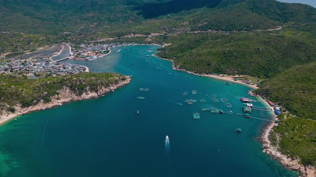 Vinh Hy Bay Resort turquoise water and vibrant green cliffs, summer, Scenic aerial timelapse