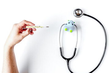 stethoscope, thermometer and hands on doctor's office desk background top view mockup