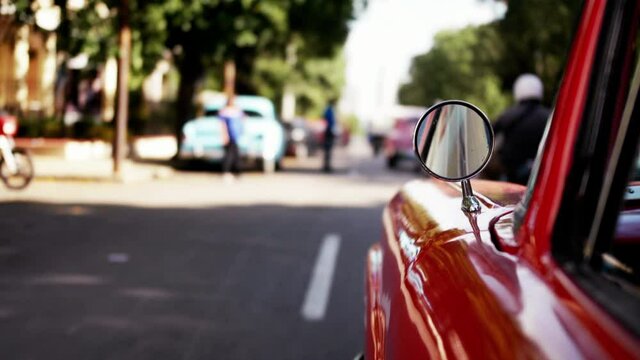 Selective focus of the side of a car driving along the streets of Havana in Cuba. 