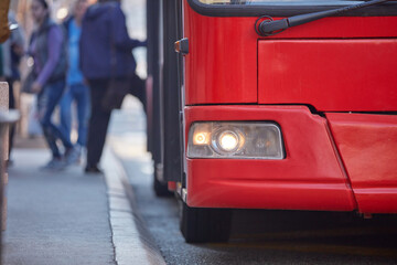 Naklejka premium Public transportation - bus in urban surroundings.