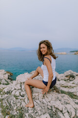 Woman sunbathing and posing at the beach at the ocean