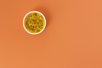 topview of vitamin d-3 softgels, with negative space. dietary supplement copyspace. mental wellbeing and personal health concept