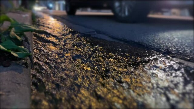 Water sewage flowing in street after rain
