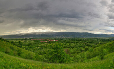 Storm scene with green hills and dark clouds