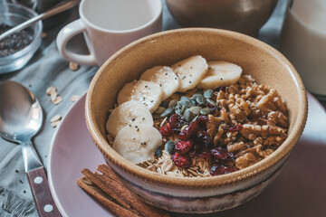 Healthy granola breakfast with dried fruit, seeds and bananas
