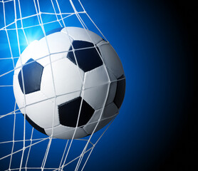 Soccer ball in goal on blue