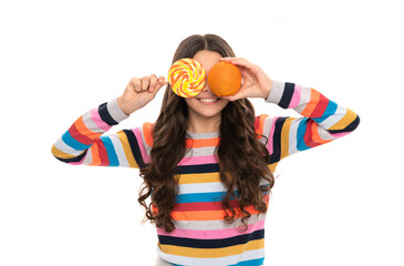 happy child in colorful sweater with orange fruit and lollipop isolated on white, happiness