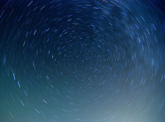 Star trails with north star in the center showing Earth rotation - 435849223
