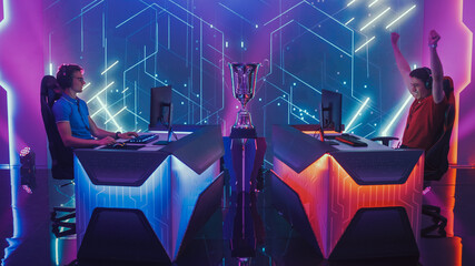 Two Professional Esport Gamers Compete in a Video Game on a Championship Arena, One Loses Round Disappointingly and Second Celebrates with Triumph. Duel Speedrun Streaming Cyber Gaming Tournament.